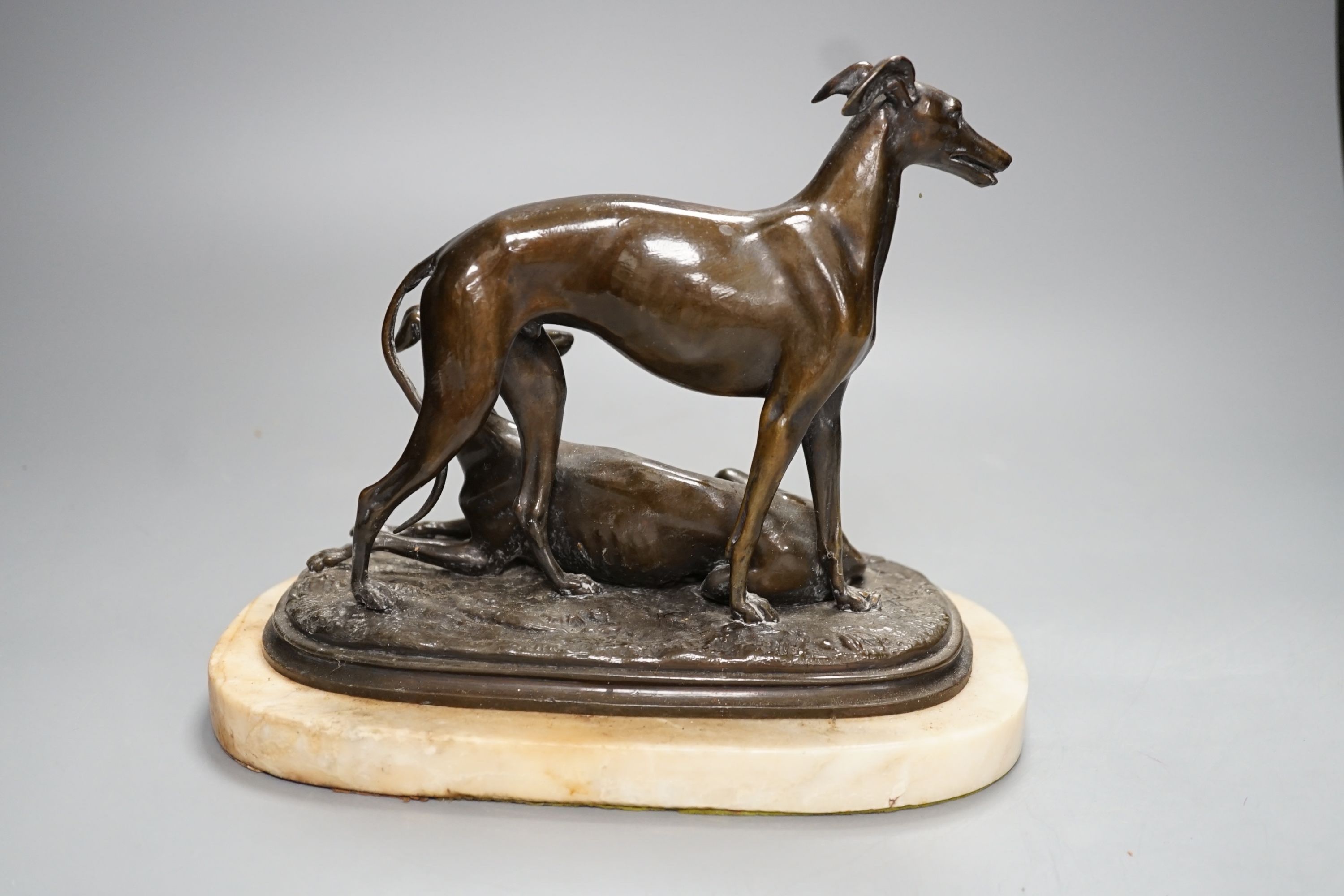 A bronze sculpture of a greyhounds on alabaster base, one seated and the other standing - 20cm high